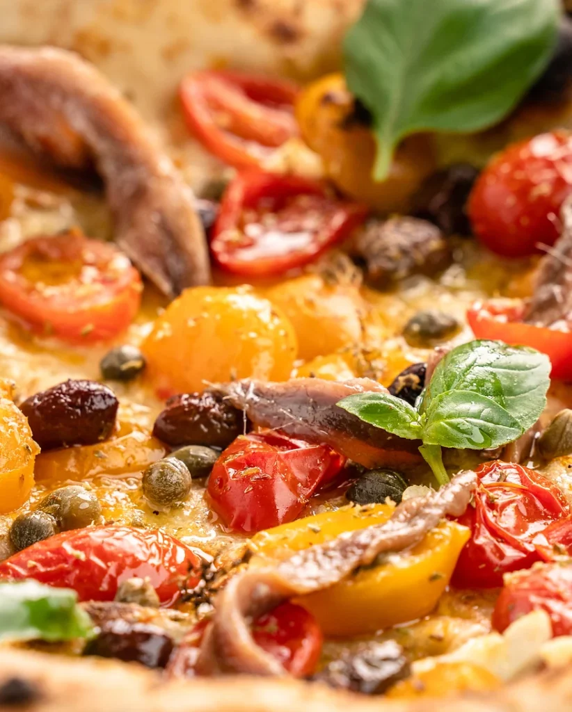 in der Nahaufnahme sieht man das Zusammenspiel der einzigartigen Zutatenmischung: Sardellen, Kapern, Oliven und Tomaten